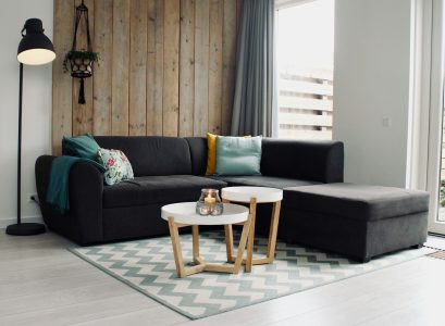 light candle on round white coffee table and sectional sofa