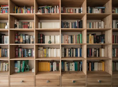 books on brown wooden shelf